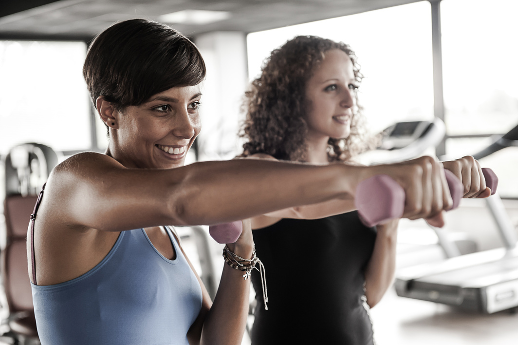 Running on treadmill in gym or fitness club – group of women and